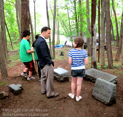 New Sloatsburg Elementary School Principal Joseph Lloyd stands with students at the Sloatsburg Cemetery during the annual History Day tour.
