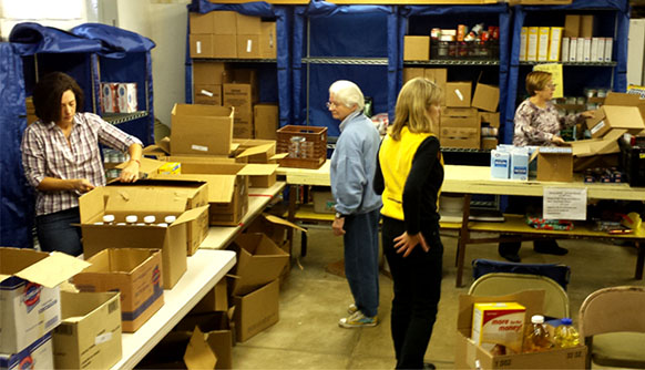 Volunteers work to put together special Thanksgiving boxes at the Sloatsburg UMC Food Pantry, which serves the surrounding community.