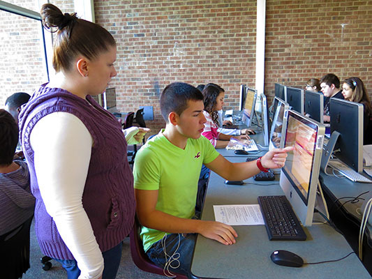 Science and AVID teacher Colleen Stritmater works with Suffern High School senior Will Mazariego on his college application during a November AVID class.