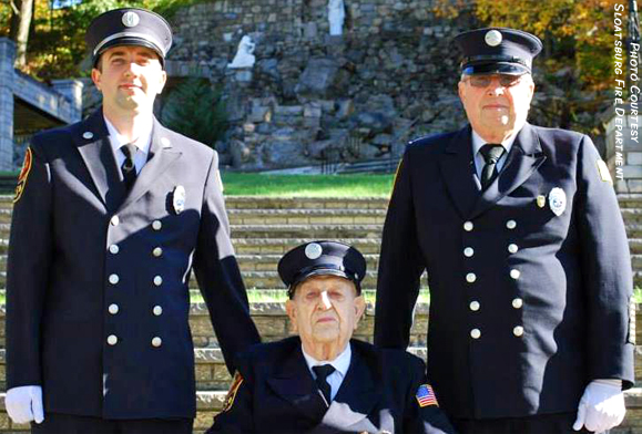 Three generations of firefighters: Gus Stritmater, Sr., seated, with his son Gus Jr (r) and grandson Matthew (l) in 2014 at the Sloatsburg Fire Department’s annual group photo. Gus Sr. started the tradition of firefighting Stritmaters in 1946 which continues today.