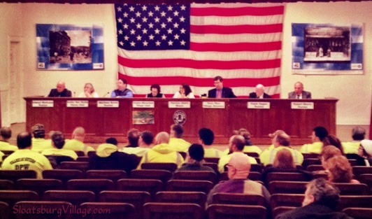 Recent Suffern Village Board meeting where supporters of the village DPW wore yellow shirts. Due to Suffern's cash on hand issue, the village sought a bridge loan through the end of its fiscal year which helped pay DPW overtime.