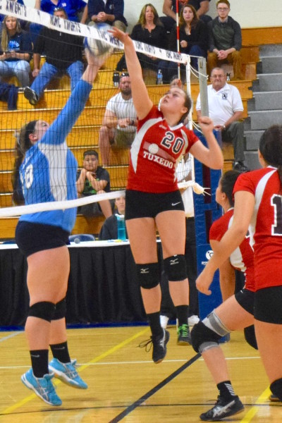 Emily Dowling of the George Baker High School Tornadoes goes up high for a block in recent tournament play. The Lady Tornadoes finished the year with a winning season.