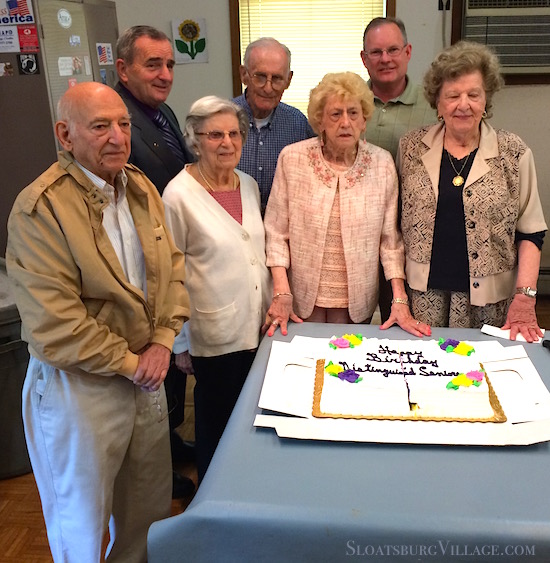 The Sloatsburg Senior Center recently celebrated residents who turned 90 years old. From left is Vince D'Andrea, then, in white, Angie Massaro, in the blue shirt is Harrison Bush. Next to Angie in pink, is Mary Nattini, and next to Mary is Ann Talercio. In the left background is Sloatsburg Mayor Carl Wright and Village Trustee Peter Akey.