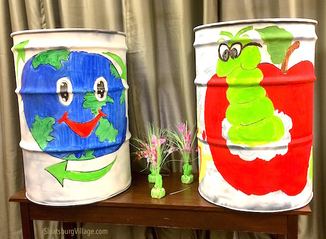 Two of the six can currently being painted by Sloatsburg kids during the summer paint-a-garbage- can program.