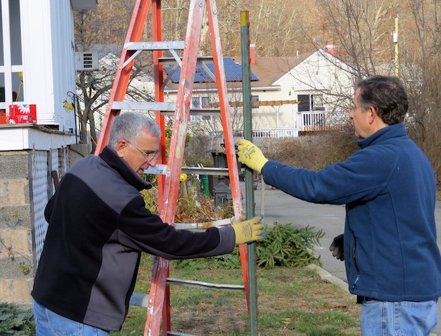 Dennis Trotter and Peter Bush put up seasonal decorations at Harmony Hall in Sloatsburg, NY.